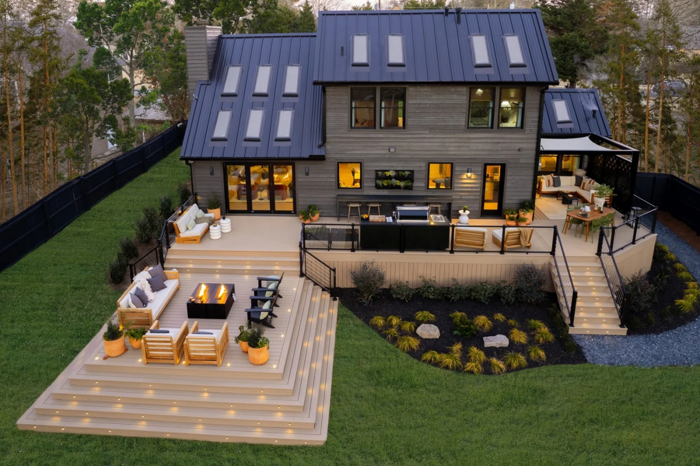 A terraced deck with illuminated steps and outdoor seating at dusk