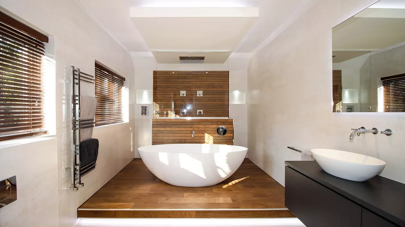 A tiled wetroom with a freestanding bath and a level-entry shower